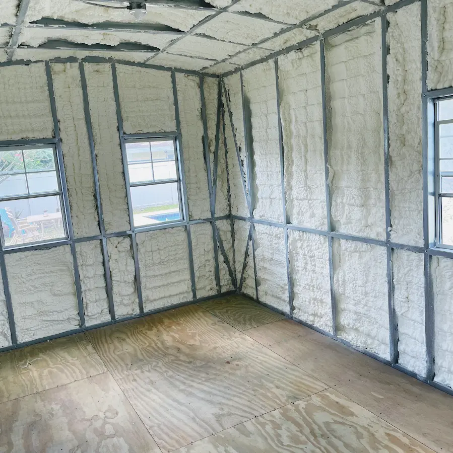 Closed-cell spray foam insulation applied to wall cavities in a residential project in Ayden